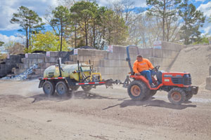 Watering the supply yard to cut down on dust